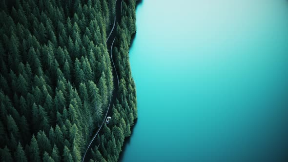 Aerial View Of Car Driving Through The Forest And The Lake alt