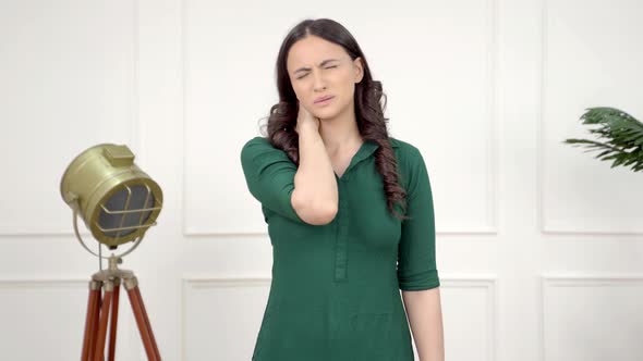 Indian girl suffering from neck pain alt