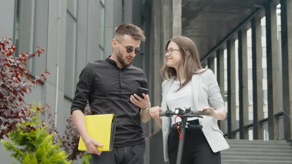 Two Modern Young Successful People, a Businessman and a Businesswoman, Communicate with Each Other alt