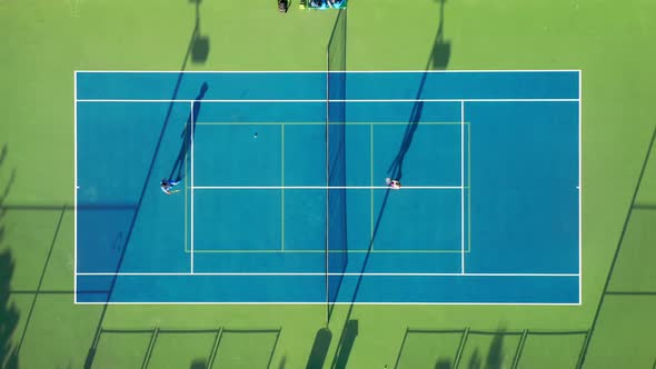  Aerial Top View of Tennis Players Greeting Each Other and Crossing Rackets alt