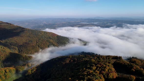 Aerial View of Autumn Carpathian Mountains Above the Clouds alt