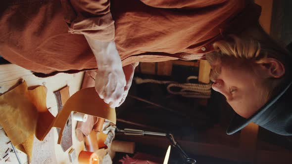 Man Working with Leather in Workshop alt