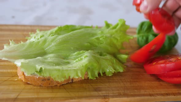 Finishing Homemade Nutrition Breakfast with Sandwich Lettuce Leaf Tomato