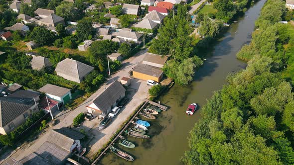 Boat Floating on the Canal in a Small Village alt