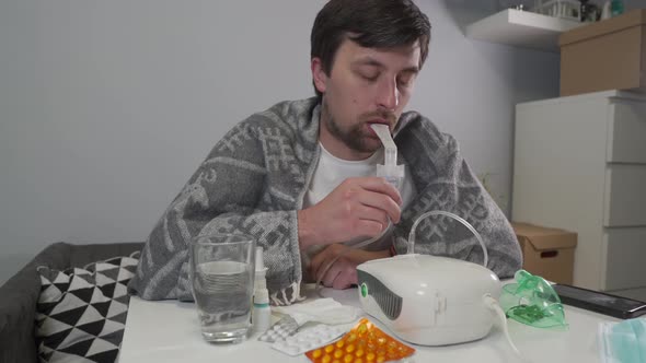 Man Does Inhalation at Home During an Illness Pneumonia Infection with Coronavirus Covid 19 alt