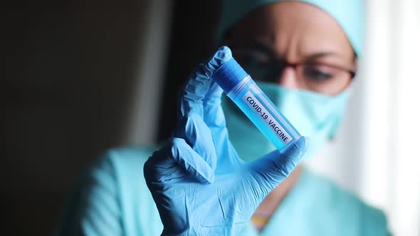 Doctor holding a recipient with the coronavirus COVID-19 vaccine