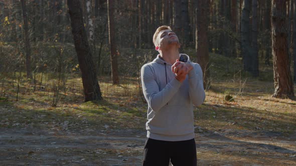 Young Man Is Warming Up In Forest