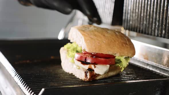 Cooking Sandwich on an Electric Grill in a Fast Food Restaurant Close Up View