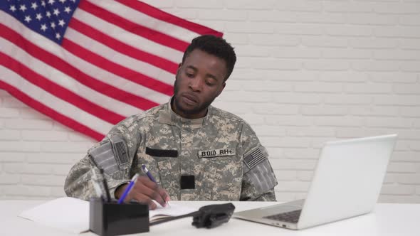 American Soldier Working on Laptop in Headquarters Building alt