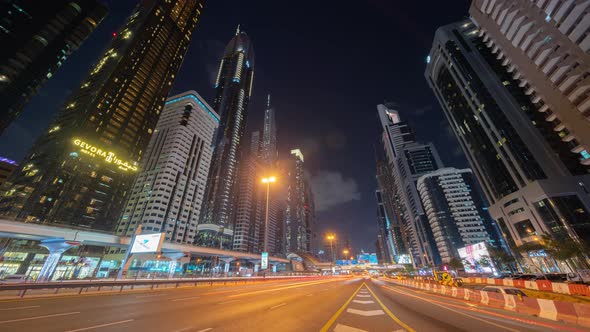 Time lapse of car light trails on road or street in Dubai Downtown skyline and highway, United Arab alt