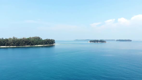 Cinematic aerial view of island in the beautiful blue ocean.