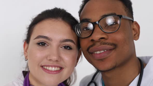 Young African doctor with a European girl of a doctor. Treatment concept. alt