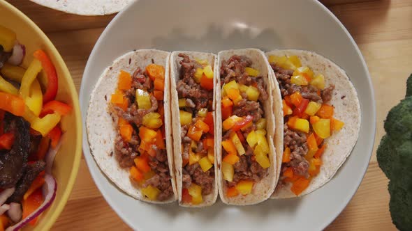 Cooked Tacos and Bowl with Beef Strips and Veggies on Table alt
