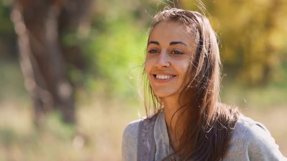 Carefree Smiling Woman Tourist Walking Outdoors Along Forest alt
