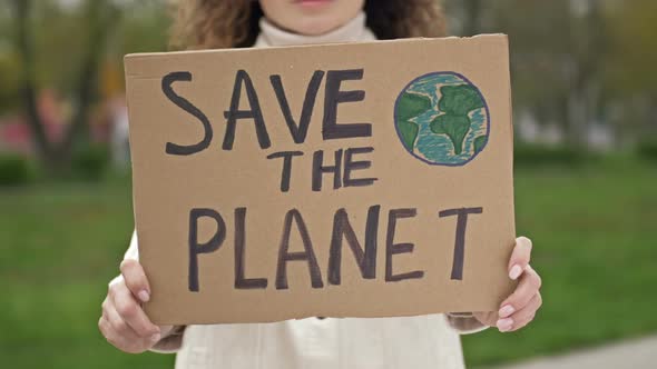 Woman with a Poster SAVE THE PLANET