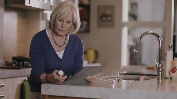 Senior Adult woman reading about medicine at home