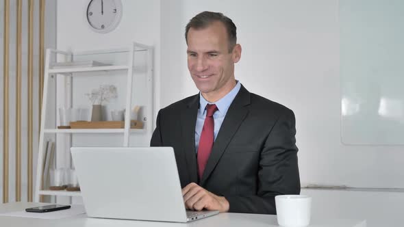 Middle Aged Businessman Talking During Online Video Chat alt