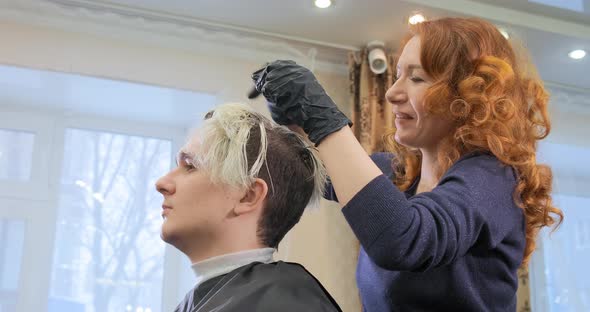 Professional Hairdresser in Black Gloves Combs Guy Hair alt