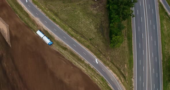 Truck crash drone shooting. Truck lies inverted in a ditch. Truck driver has an accident