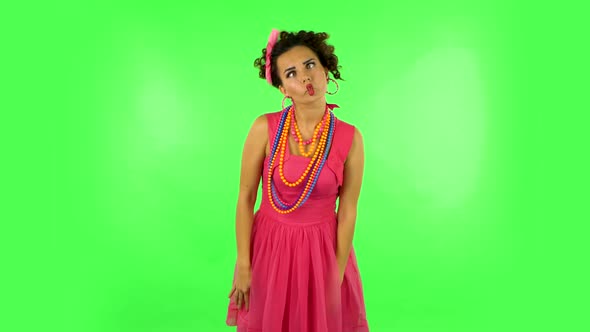 Lovely Girl Funny Dances, Poses for Camera Makes Funny Faces on Green Screen at Studio alt