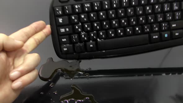 A coffee drink spills onto the keyboard.