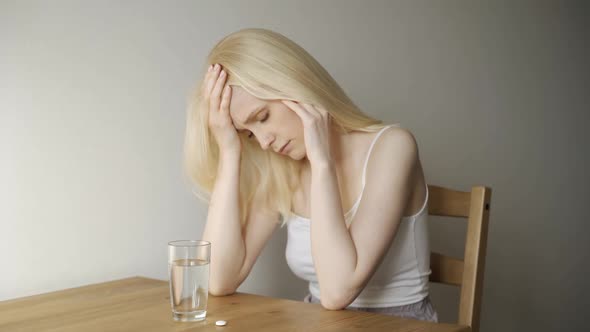 Unhealthy Woman with Pained Facial Expression Feels Unwell Takes Pill Analgetic Medication alt