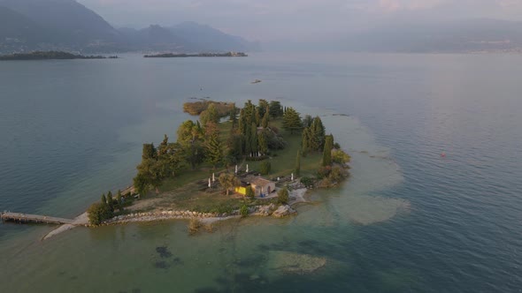 Aerial view of tiny bar on San Biagio Island on lake Garda, northern Italy alt
