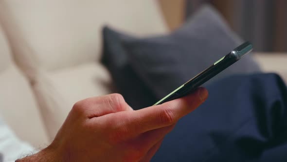 Close Up of Businessman Browsing on Smartphone alt