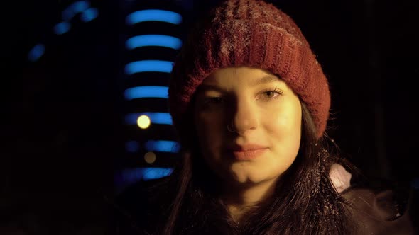 Woman Looking at Camera Winter Evening Walk Snowfall Night City Portrait