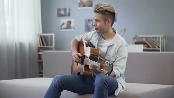 College Guy Enjoying Melody for His New Song, Talented Teenager Playing Guitar alt