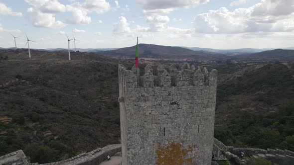 Main keep with Portuguese flag at Castle of Sortelha; aerial orbit