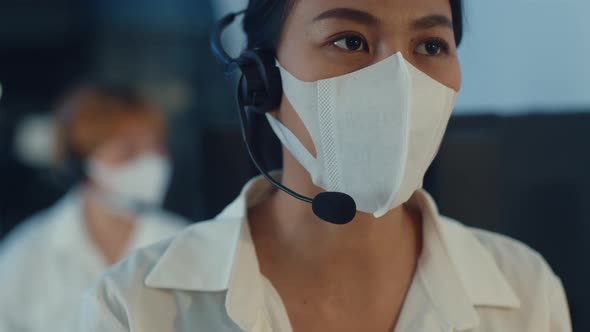 Asia young call center team or customer support service executive wearing face mask prevent.