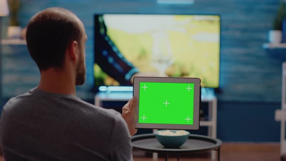 Person Using Modern Tablet Horizontally for Green Screen alt