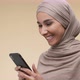 Positive Young Middle Eastern Woman Reading Exciting News on Cellphone Browsing in Internet Slow - VideoHive Item for Sale