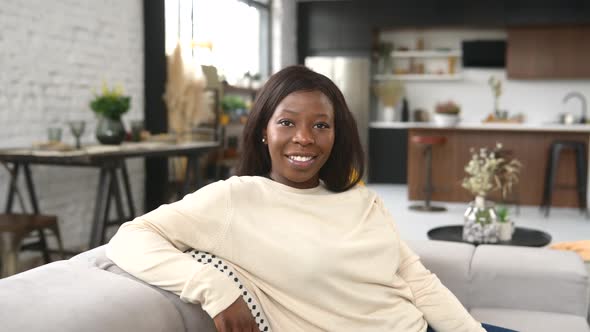 Charming Multiracial Woman Rest at Home Serene Ethnic Female Sitting on the Comfortable Couch alt