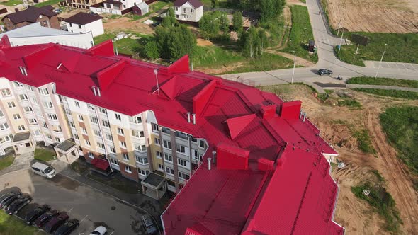 A Modern New Building in the Suburbs Aerial View of the Red Roof of the House alt