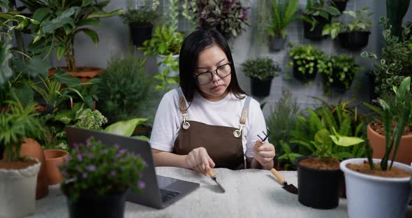 woman checking Gardening equipment alt