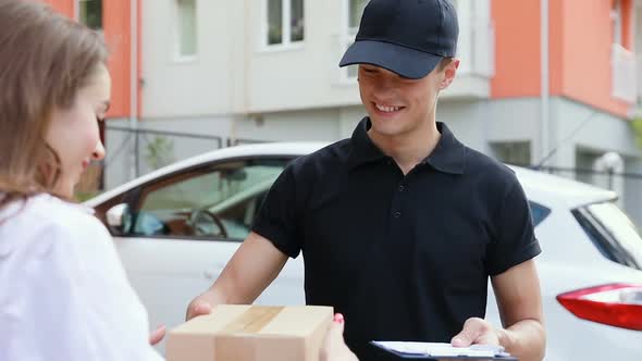 Delivery Service. Courier Delivering Box To Woman alt