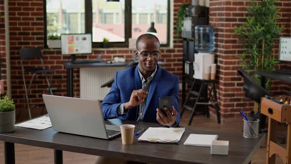 Financial Analyst Using Smartphone to Attend Video Call Meeting alt