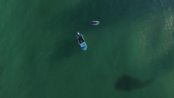 Boats in turquoise green sea alt