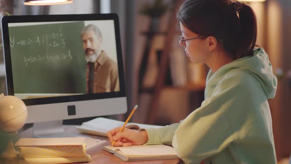 Teenage Girl Studying via Video Call on Computer at Home alt