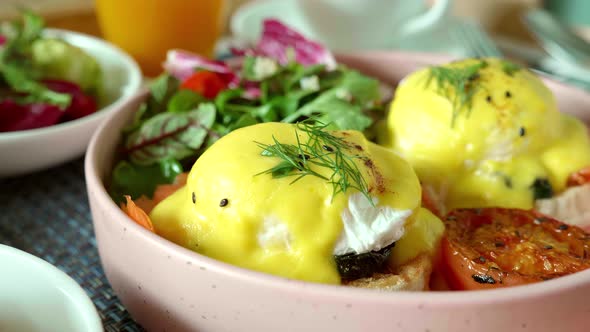 Closeup of Eggs Benedict with Salmon on Baked Muffin with Grilled Vegetable alt