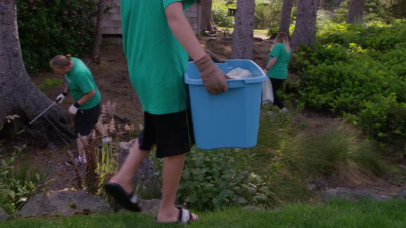 Group of volunteers cleaning up park alt