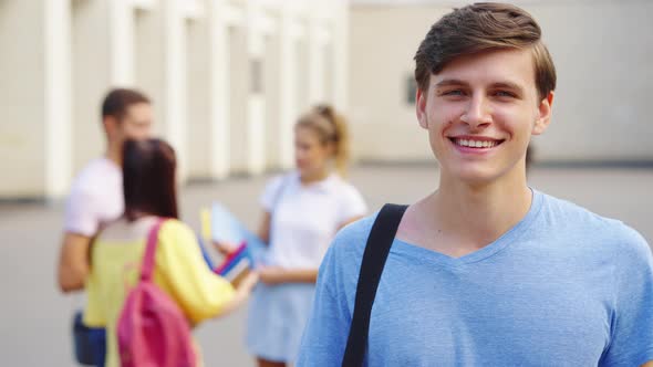 Smiling Student Looking at Camera Against College Building alt