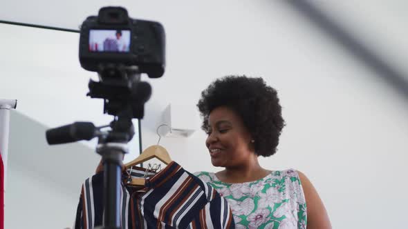 African american female plus size vlogger recording a video about fashion alt