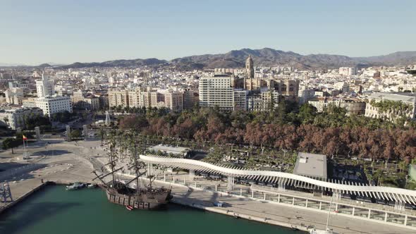 Aerial city view from over port promenade with white pergola, Malaga, Spain