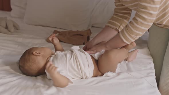 Parent Putting Diaper on Child alt