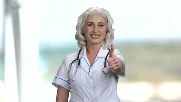 Senior Woman Doctor Showing Thumb Up. alt