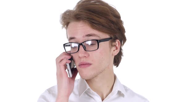 Man in Glasses at Work Talking on Smartphone with Customer alt