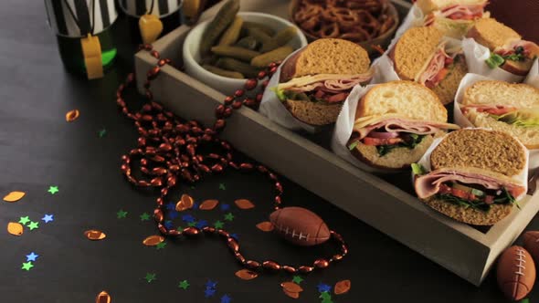 Game day football party table with  sub sandwich and snacks. alt